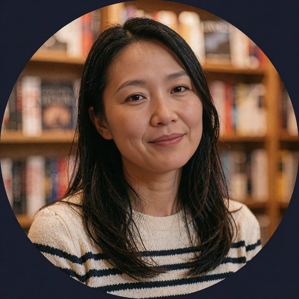 Woman with long black hair in a striped top inside a bookstore, avatar for a sample dating chat opener